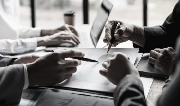 Startup business meeting to analyze and discuss the situation on the financial report in the meeting room. Investment Consultant, Financial advisor and accounting concept